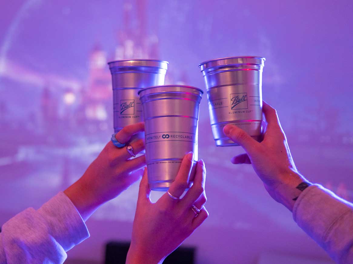 Three Ball Aluminum Cups held in a cheers motion